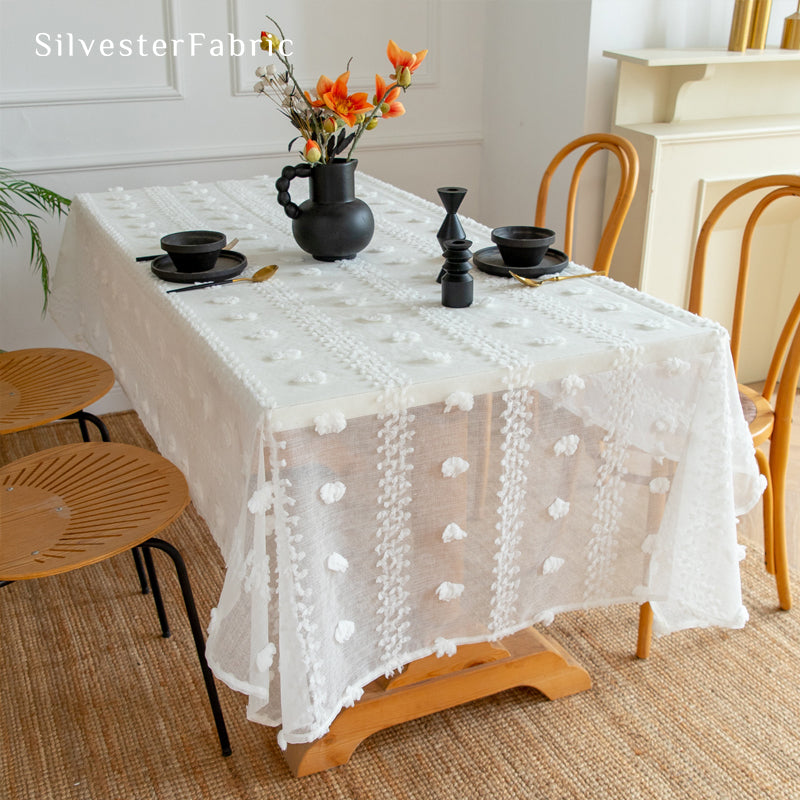 white French tufted tablecloth draped over rectangle table