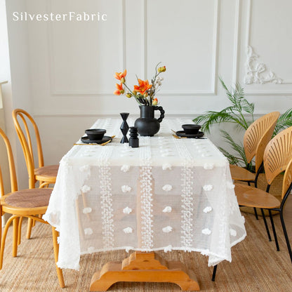 white French tufted tablecloth laid flat on dining table