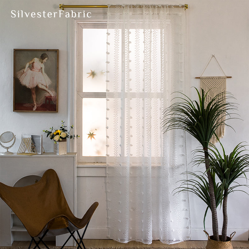 White sheer curtains hanging in the living room window