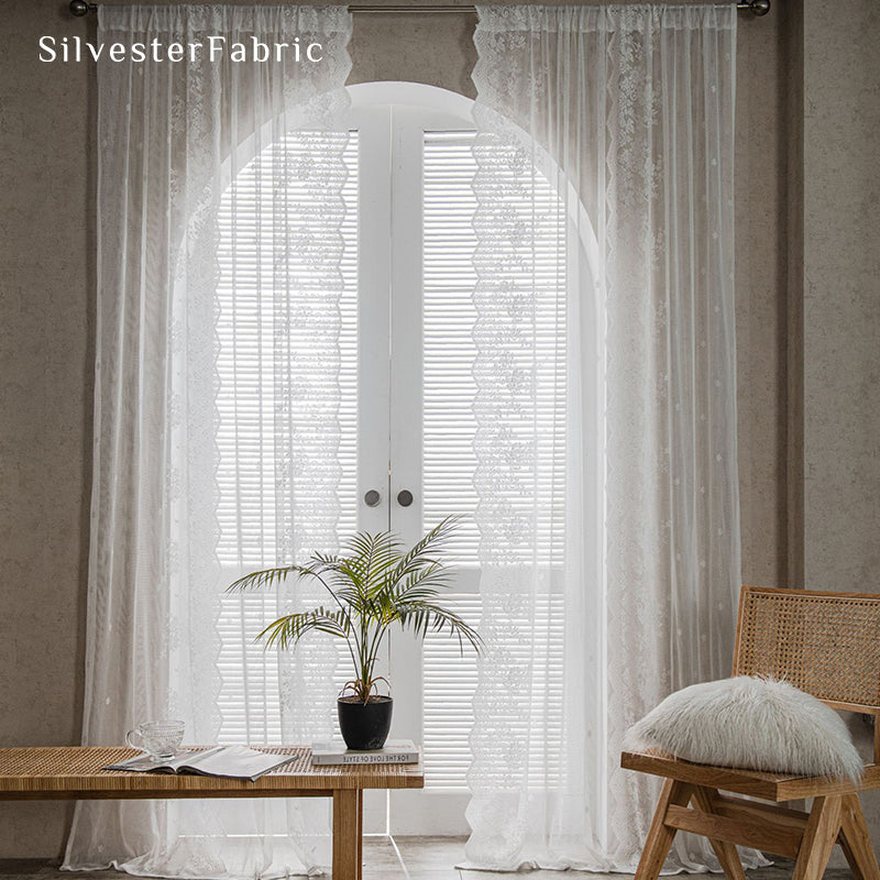 Lace floral white sheer curtains hanging in the window