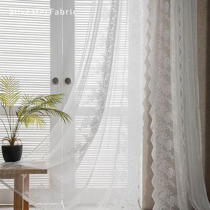 Lace floral white sheer curtains hanging in the window