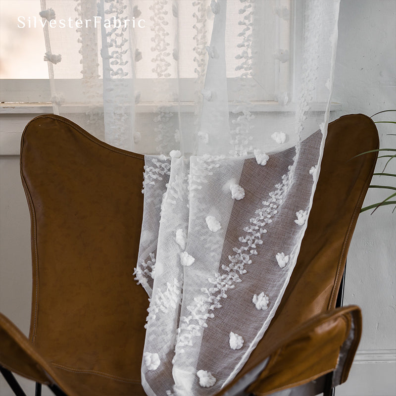 White sheer curtains hanging in the living room window