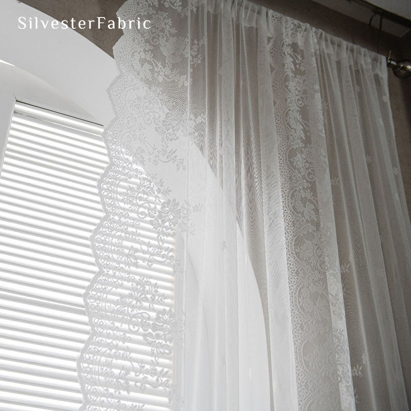 Lace floral white sheer curtains hanging in the window