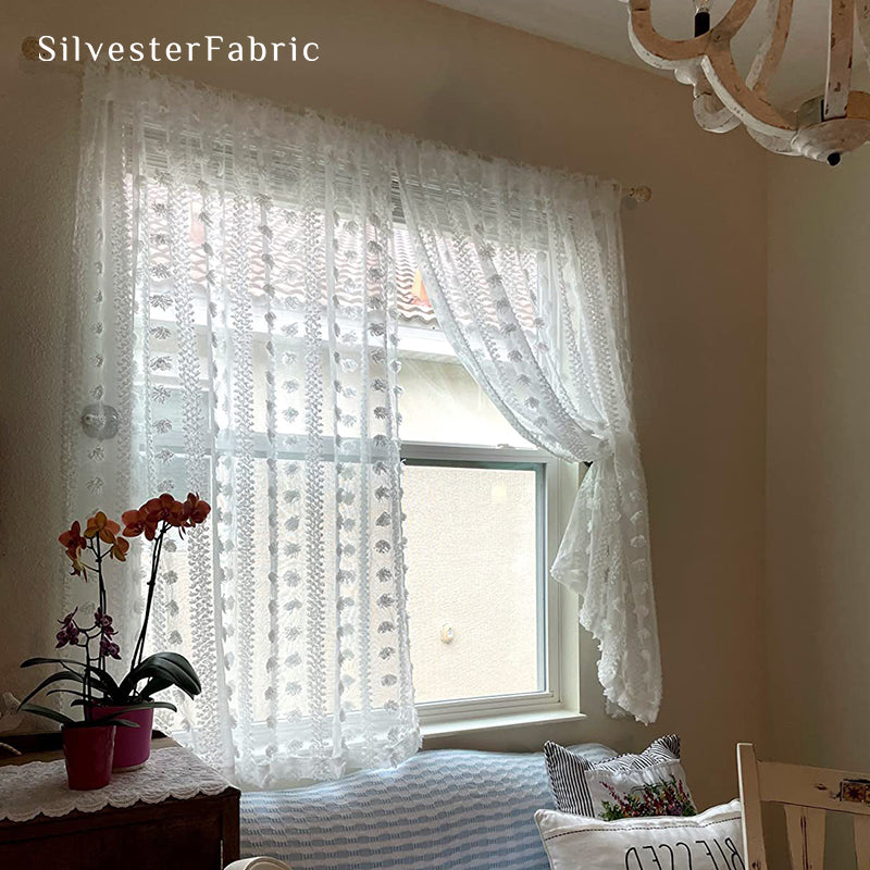 White sheer curtains hanging in the living room window