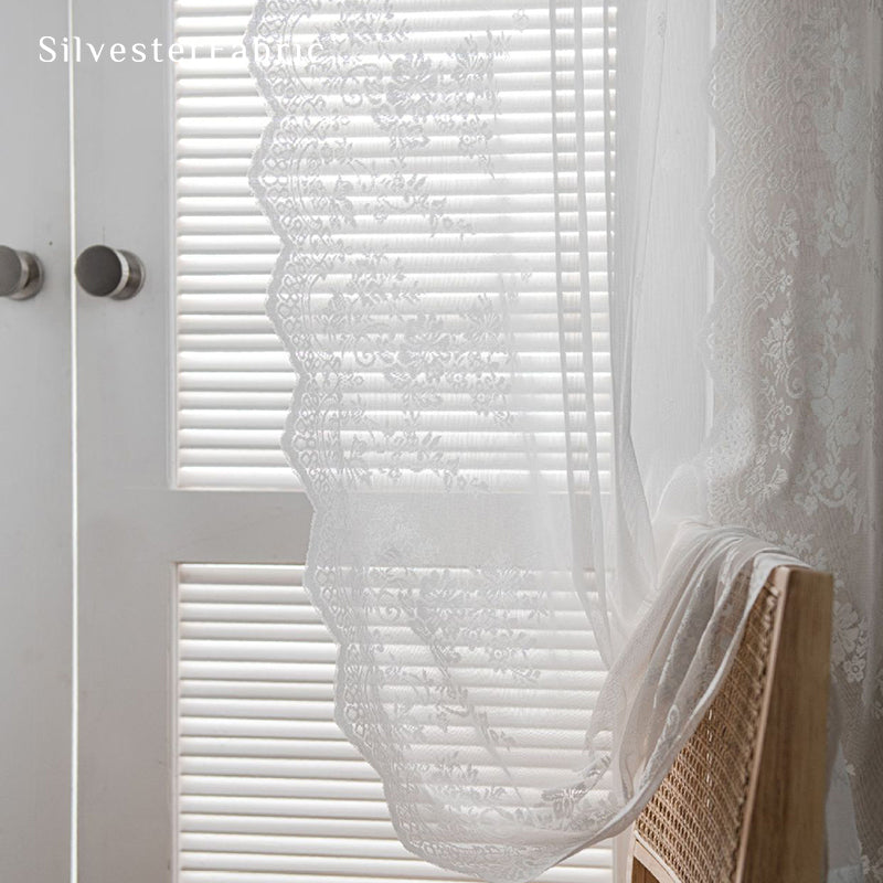 Lace floral white sheer curtains hanging in the window