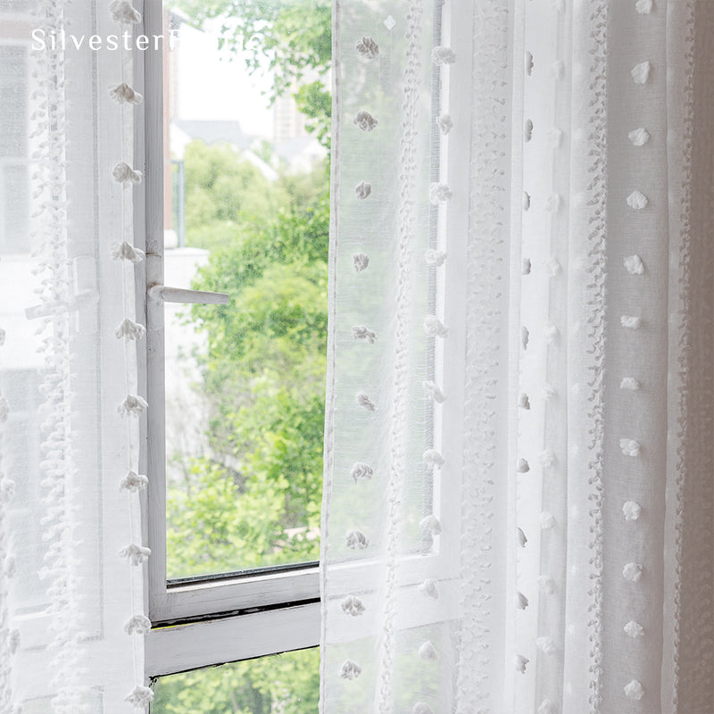 White sheer curtains hanging in the living room window