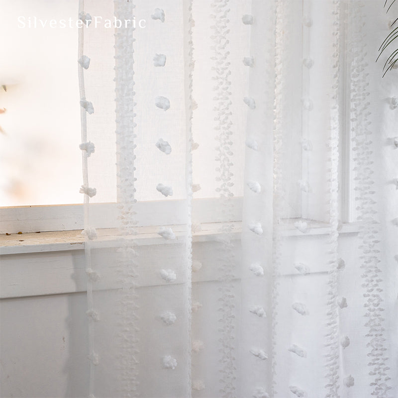 White sheer curtains hanging in the living room window