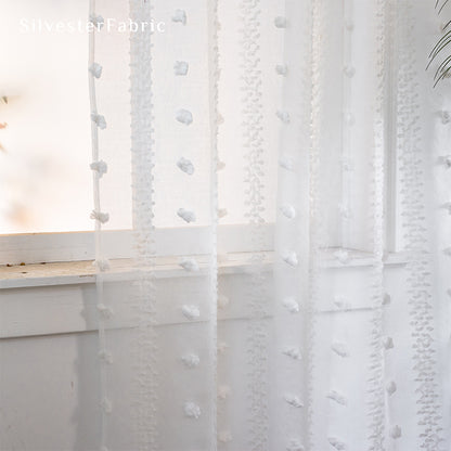 White sheer curtains hanging in the living room window