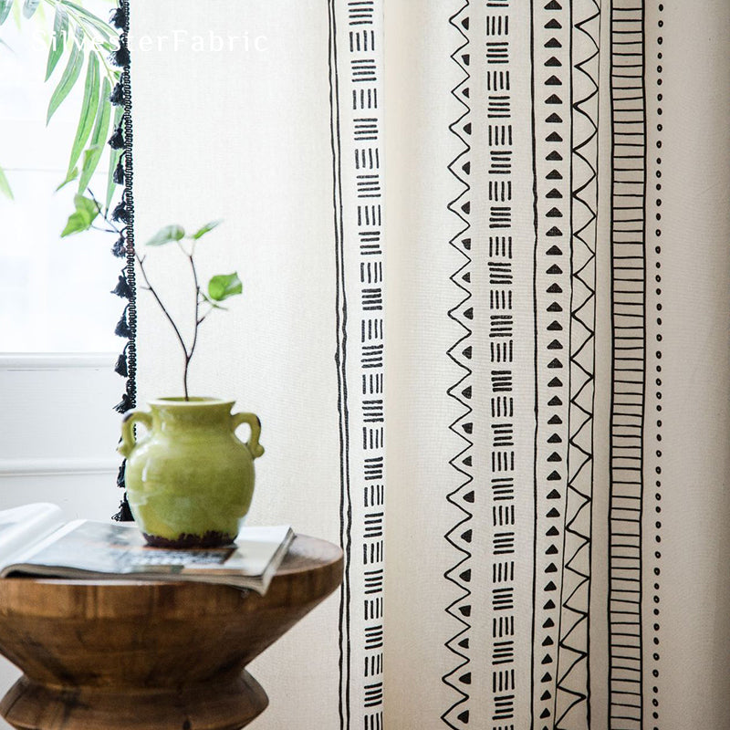 White geometric line linen curtains hanging in the bedroom window