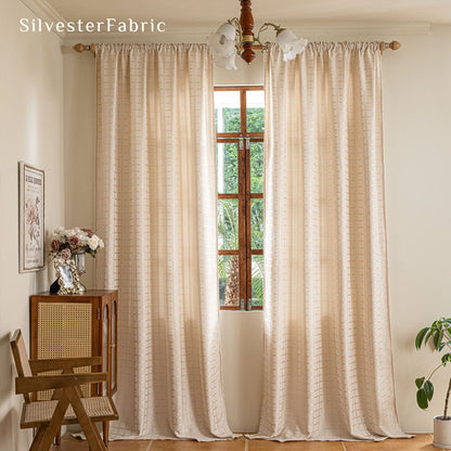 beige jacquard farmhouse curtain hanging in window