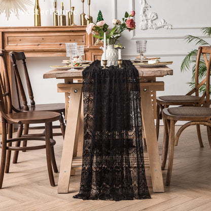 black lace table runner laid flat on dining table