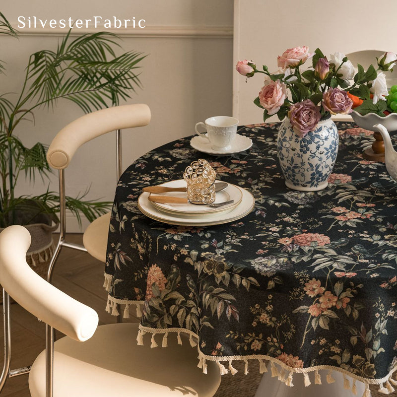 black farmhouse  floral tablecloth draped over round table
