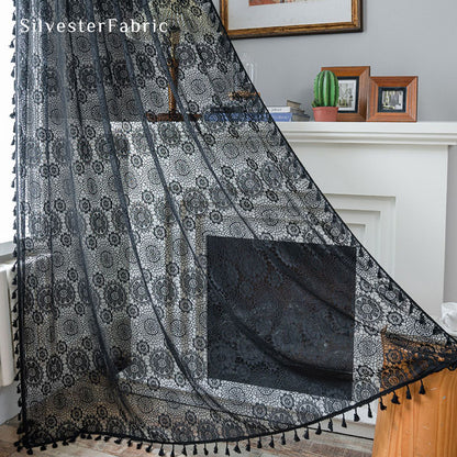 Black lace curtains hanging in the bedroom window