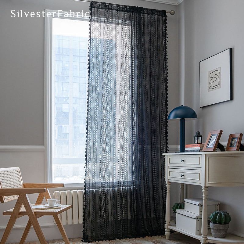 Black sheer curtains hanging in the bedroom window