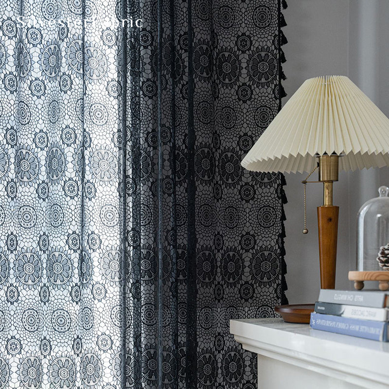 Black lace curtains hanging in the bedroom window