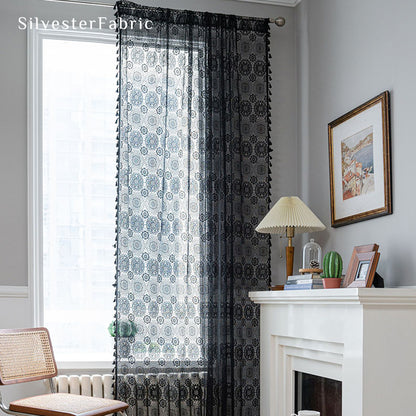 Black lace curtains hanging in the bedroom window