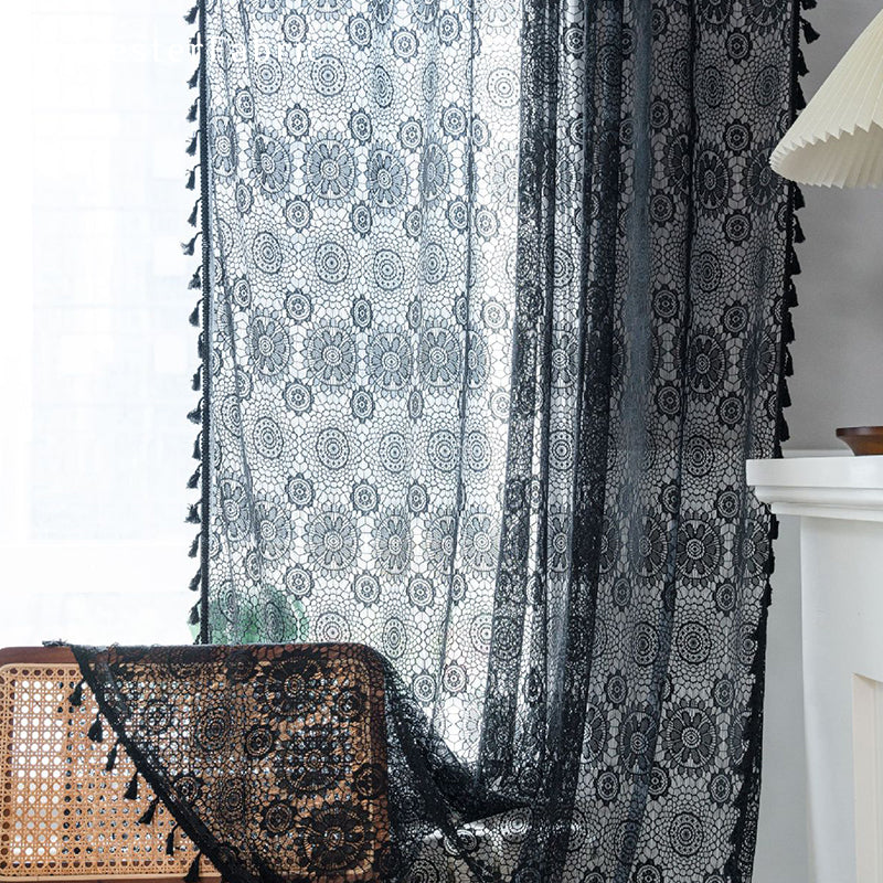 Black lace curtains hanging in the bedroom window