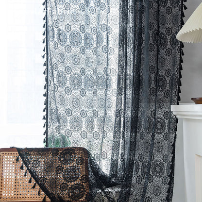 Black lace curtains hanging in the bedroom window