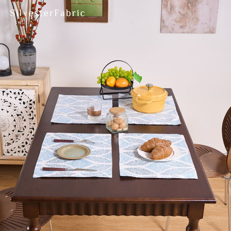 blue textured farmhouse placemats set of 4 arranged on rectangle table