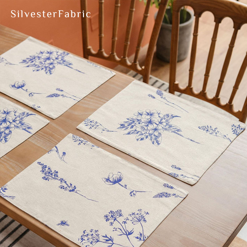 blue floral farmhouse placemats laid flat on dining table