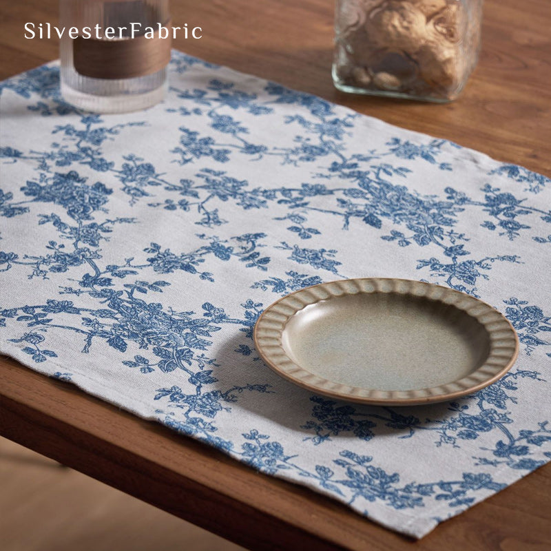 blue floral farmhouse placemats laid flat on dining table