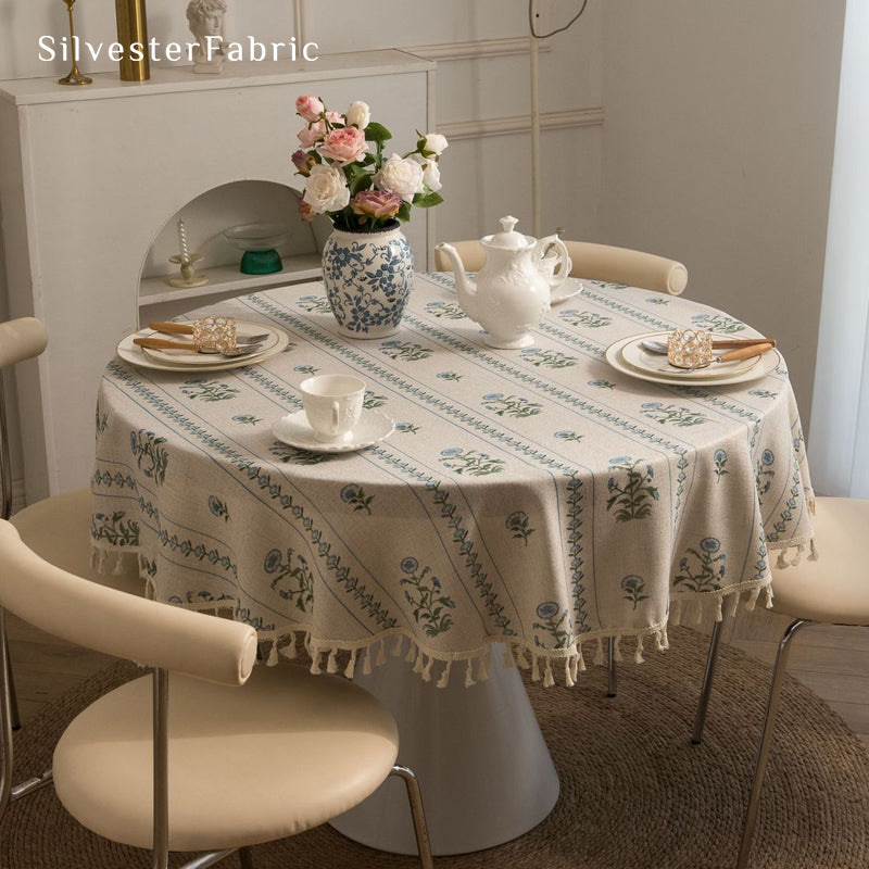 blue floral farmhouse tablecloth draped over round table
