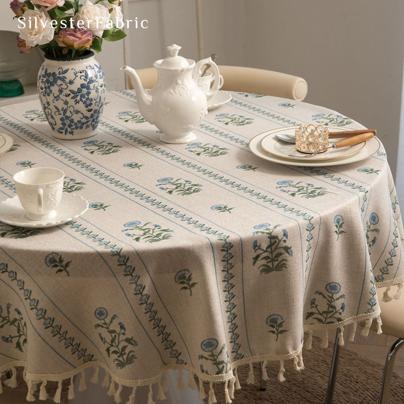 blue floral round farmhouse tablecloth laid flat on dining table