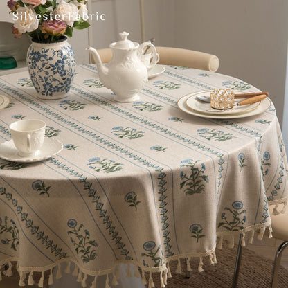 blue floral round farmhouse tablecloth laid flat on dining table