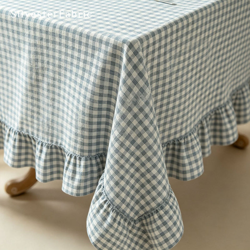 blue plaid farmhouse tablecloth laid flat on dining table