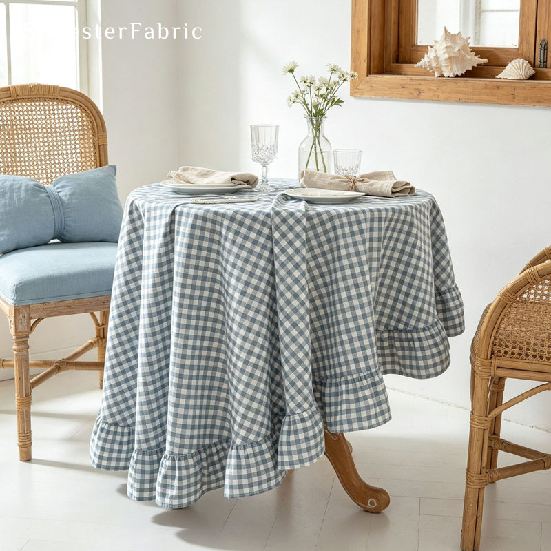 blue plaid farmhouse tablecloth draped over round table