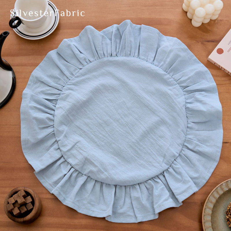blue farmhouse round placemats laid flat on dining table