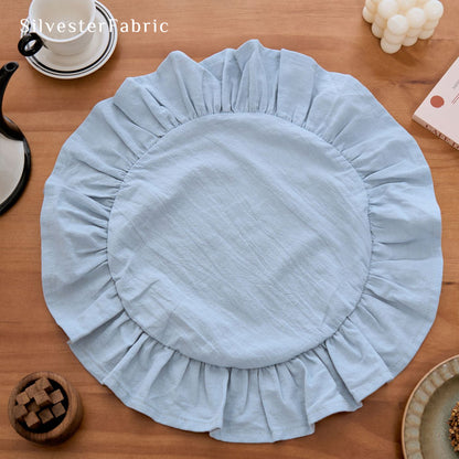 blue farmhouse round placemats laid flat on dining table