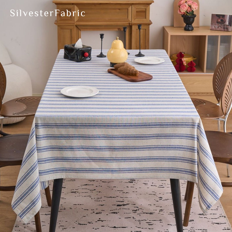 blue striped farmhouse tablecloth laid flat on dining table