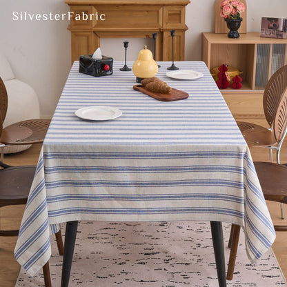 blue striped farmhouse tablecloth laid flat on dining table