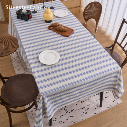 blue striped farmhouse tablecloth draped over rectangle table