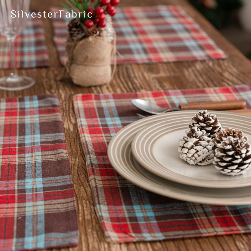 brown Christmas plaid placemats laid flat on dining table