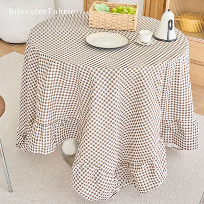 brown plaid farmhouse tablecloth draped over round table