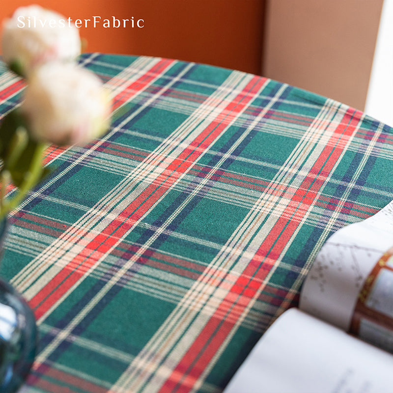 Green plaid Christmas tablecloth covering the table