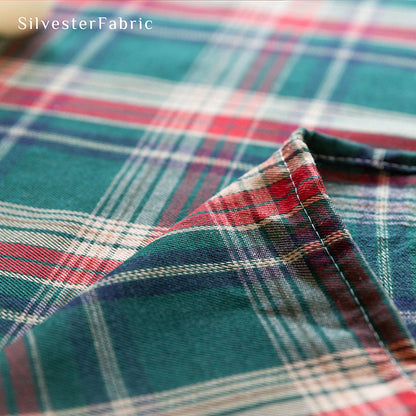 Green plaid Christmas tablecloth covering the table