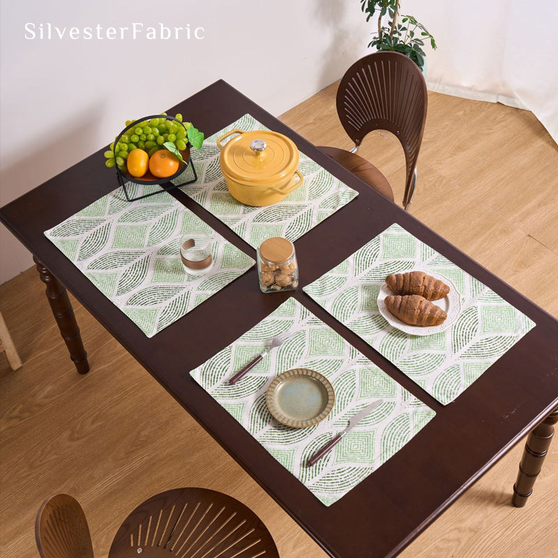 green textured farmhouse placemats set of 4 arranged on rectangle table