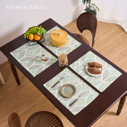 green textured farmhouse placemats set of 4 arranged on rectangle table