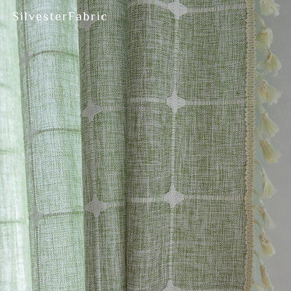 Embroidered plaid light green curtains hanging in the bedroom window