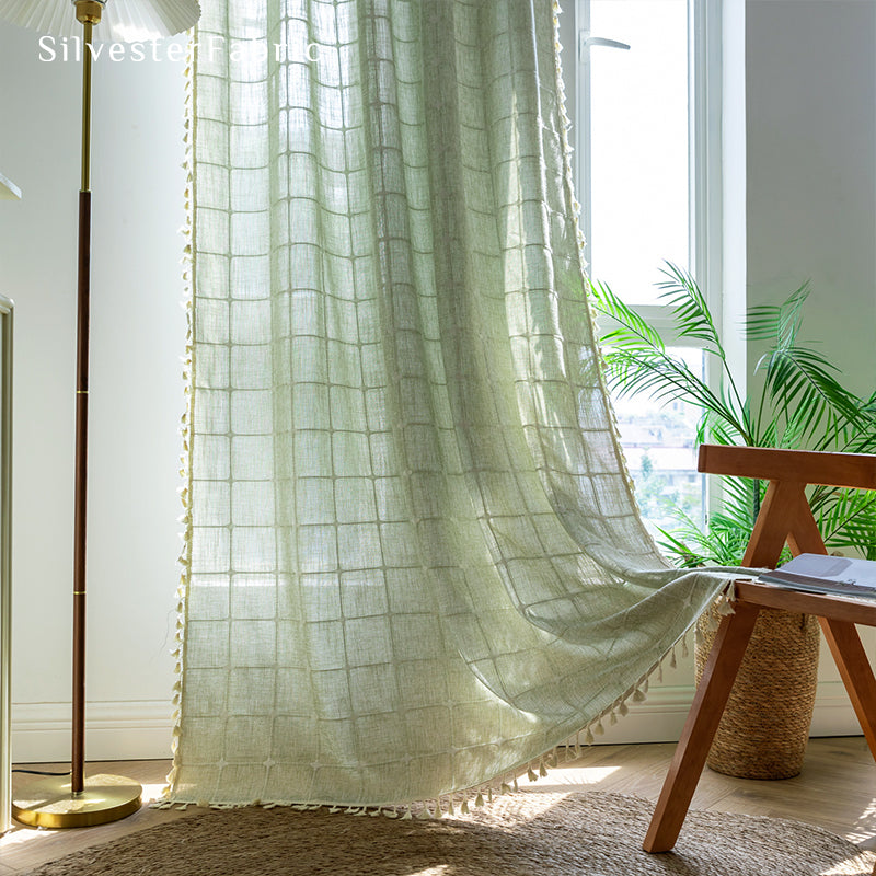 Embroidered plaid light green curtains hanging in the bedroom window