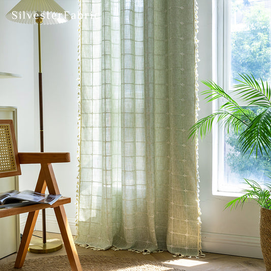 Embroidered plaid light green curtains hanging in the bedroom window