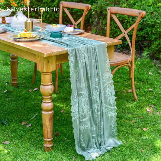 green lace table runner draped over rectangle table