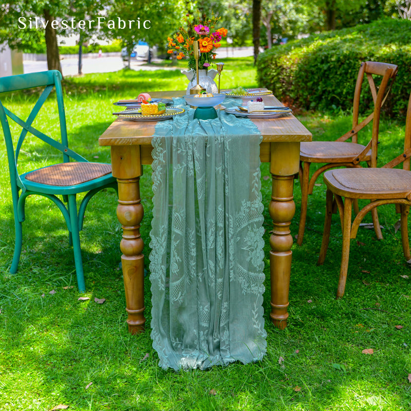 green lace table runner laid flat on dining table