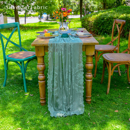 green lace table runner laid flat on dining table