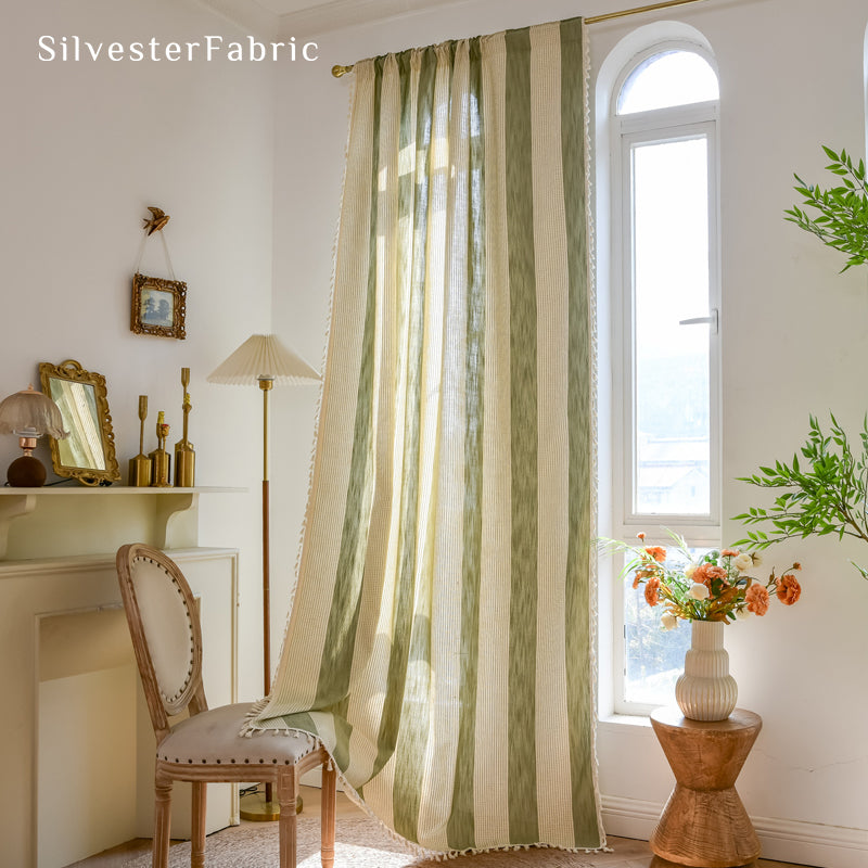 Close‑up of Green embroidered curtain corner