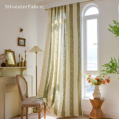 Close‑up of Green embroidered curtain corner