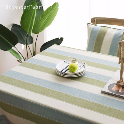 green striped farmhouse tablecloth laid flat on dining table
